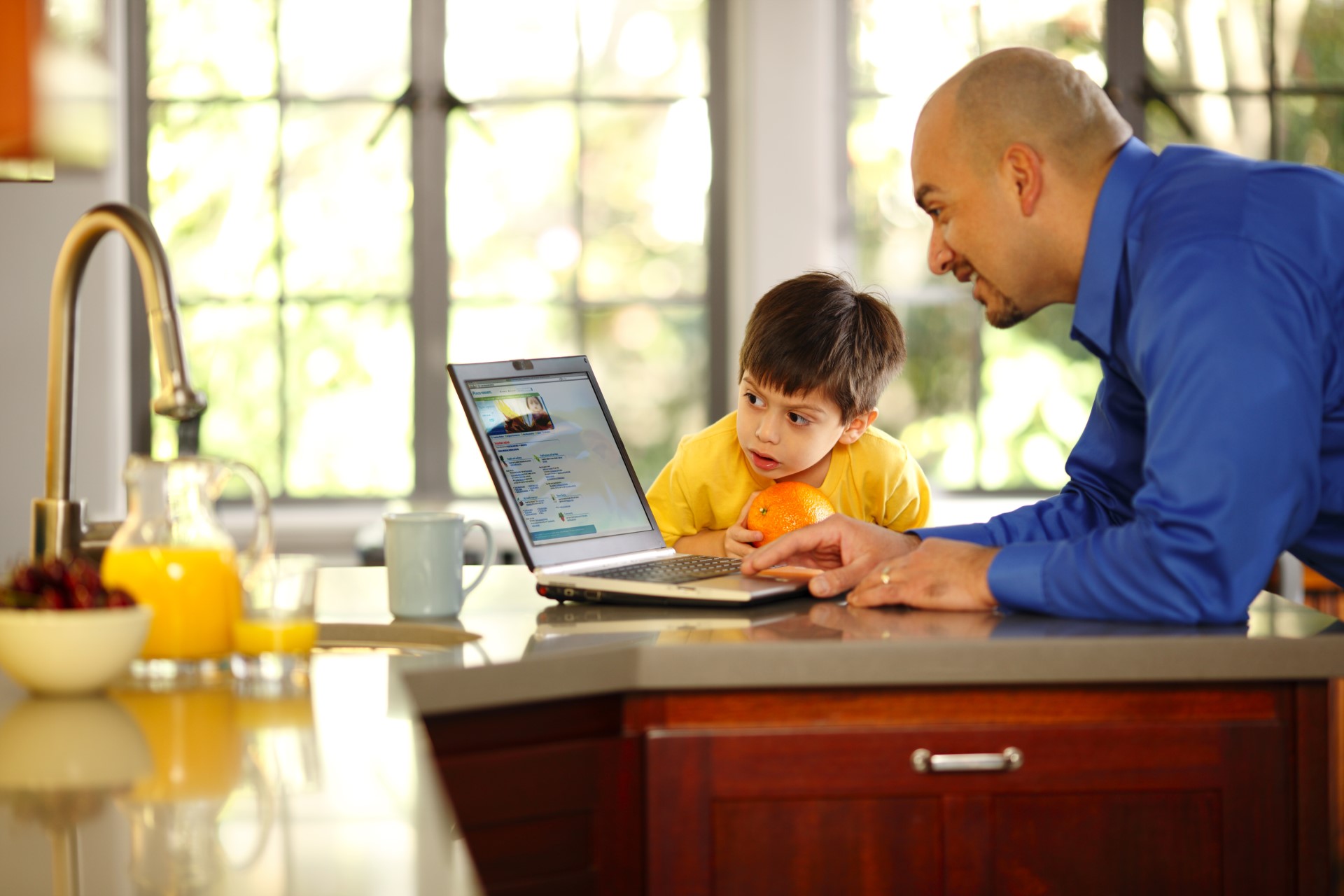 Dad and child in front of laptop