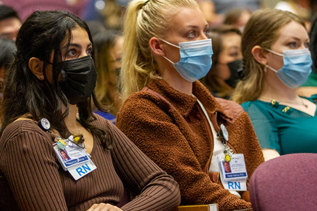 Rebecca Valencia, RN, At Left, Listens With Other Graduates To A Presentation During The Nurse Residency Graduation In May.