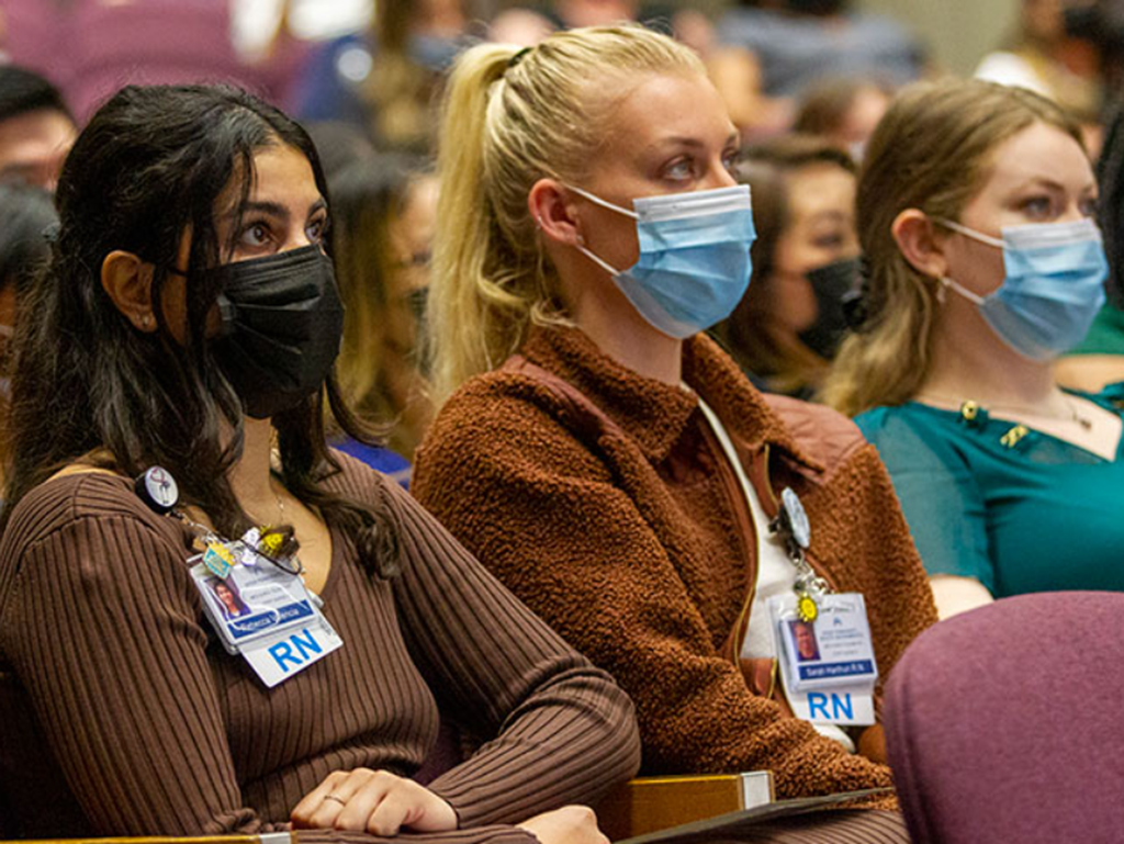Rebecca Valencia, RN, at left, listens with other graduates to a presentation during the nurse residency graduation in May.